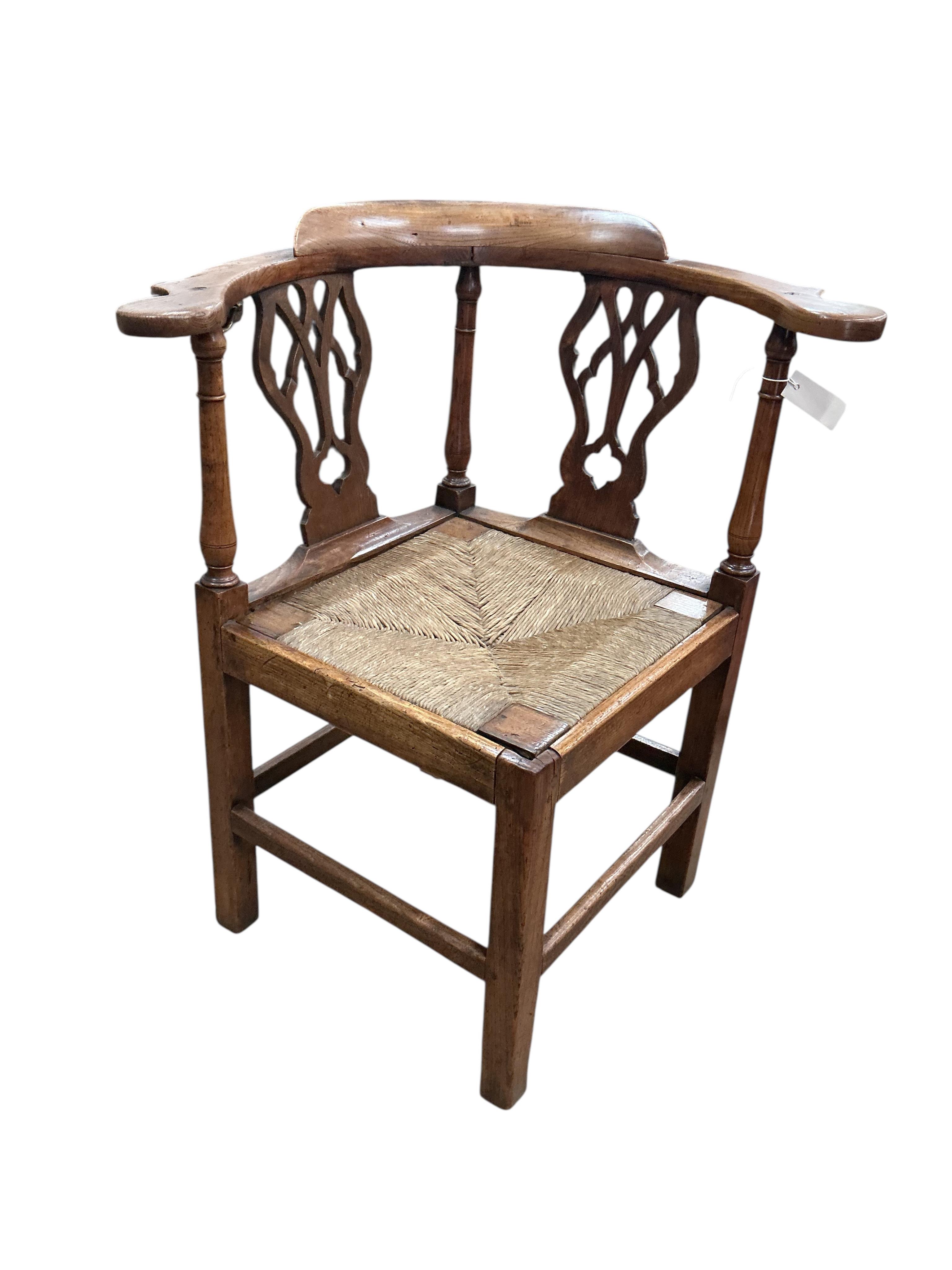 A George III oak corner elbow chair, width 75cm, depth 63cm, height 86cm